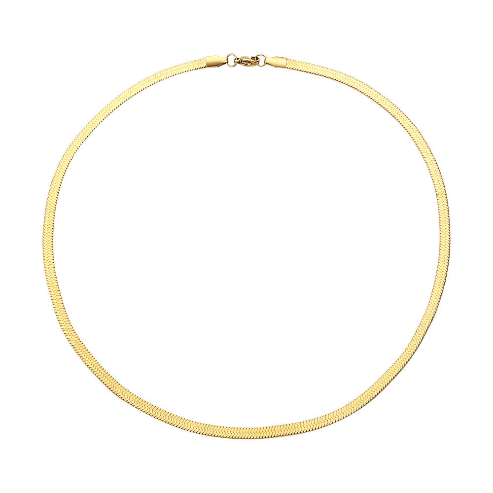 Gold snake necklace on a white background - from Aurie Jewelry essentials collection