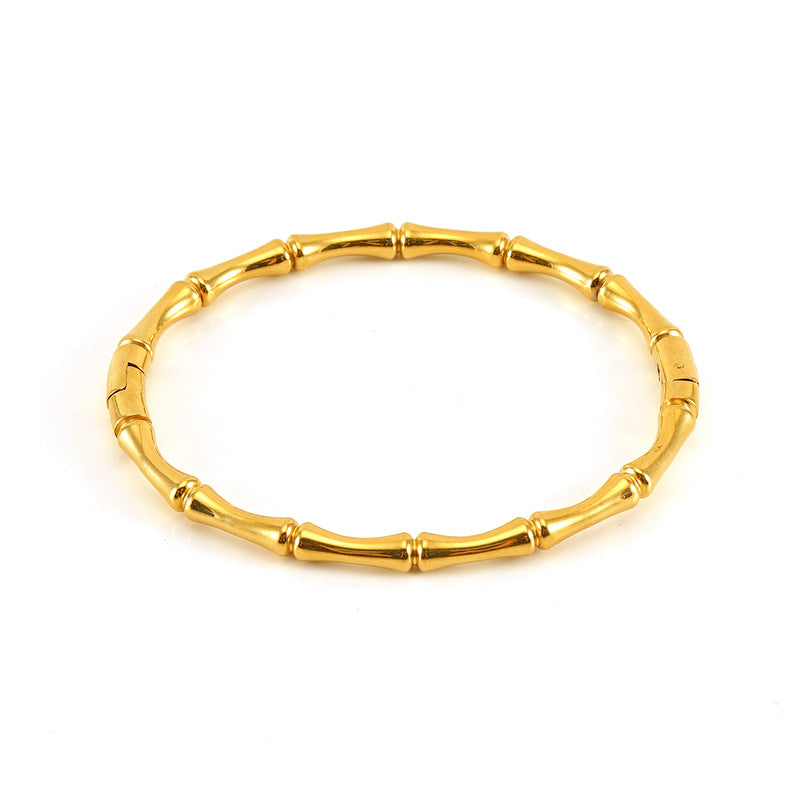Gold bracelet with bamboo design on a white background - from Aurie Jewelry bestie collection 