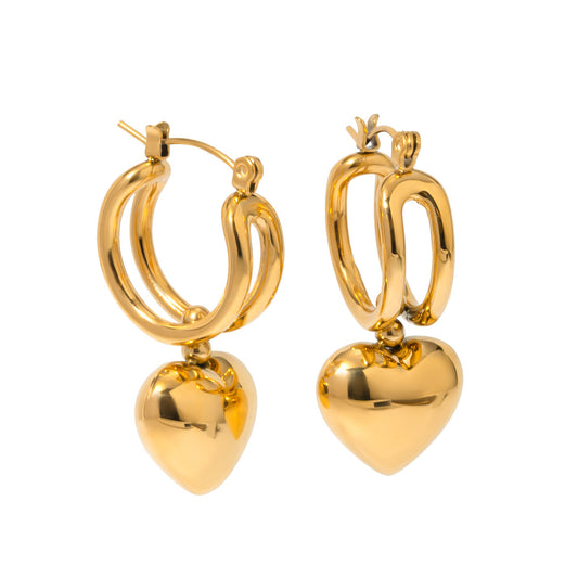 Gold hoop earrings with heart pendants on a white background - from Aurie Jewelry bestie collection 
