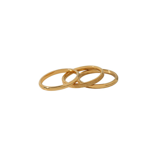 Three set of gold rings for stacking on a white background from Aurie Jewelry. 
