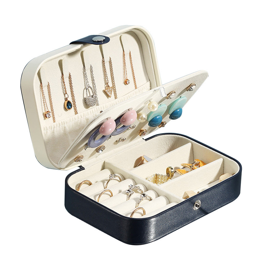 Open jewelry box with gold necklaces and earrings on a white background from Aurie Lil Things collection 