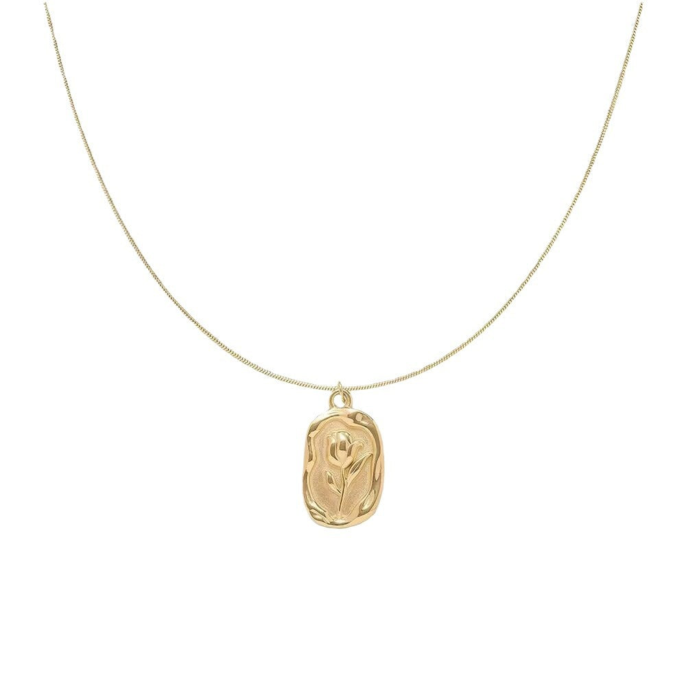 Gold necklace with a rose pendant on a white background - from Aurie Jewelry bestie collection 