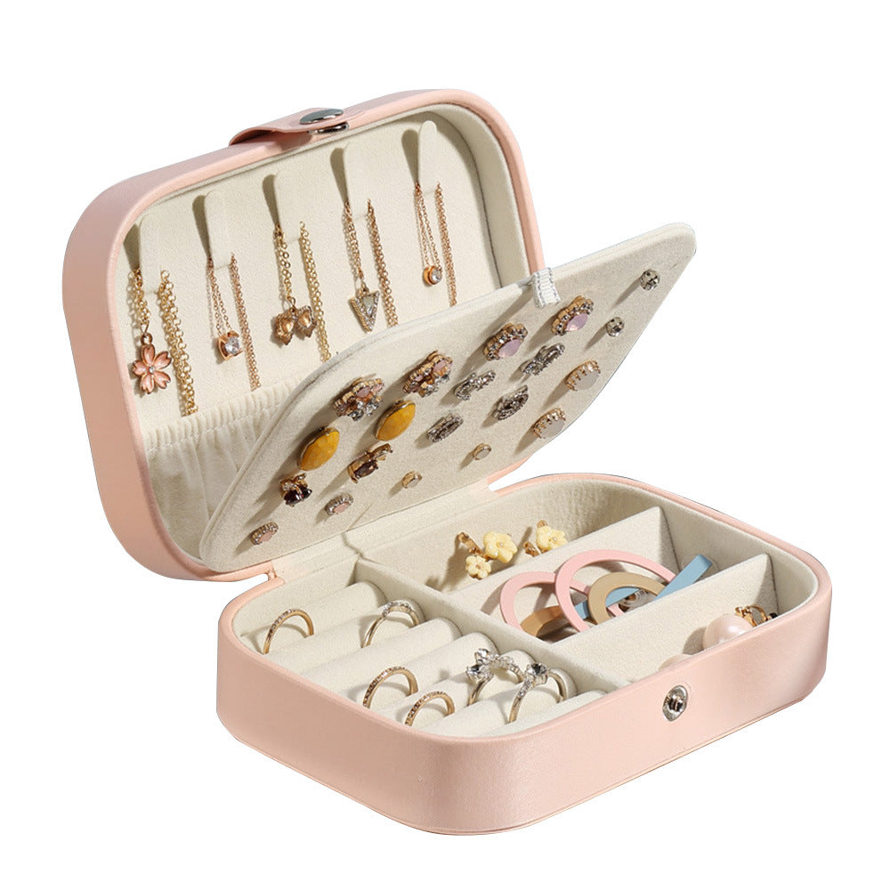 Open jewelry box with gold necklaces and earrings on a white background from Aurie Lil Things collection 